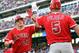 ARLINGTON, TX - JULY 30: Mike Trout #27 of the Los Angeles Angels of Anaheim Texas is congratulated by teammate Albert Pujols #5 at the plate after hitting a 2-run homer in the 3rd inning against the Rangers on July 30, 2012 at the Rangers Ballpark in Arlington in Arlington, Texas. (Photo by Layne Murdoch/Getty Images)
