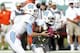 MIAMI GARDENS, FL - OCTOBER 13: Bryn Renner #2 hands the ball off to Giovani Bernard #26 of the North Carolina Tar Heels against the Miami Hurricanes on October 13, 2012 at Sun Life Stadium in Miami Gardens, Florida. The Tar Heels defeated the Hurricanes 18-14. (Photo by Joel Auerbach/Getty Images)