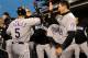 SAN FRANCISCO, CA - MAY 15: Carlos Gonzalez #5 of the Colorado Rockie is congratulated back in the dugout by teammate Tyler Colvin #21 after scoring on a Troy Tulowitzki RBI single in the fourth inning against the San Francisco Giants at AT&T Park on May 15, 2012 in San Francisco, California. (Photo by Thearon W. Henderson/Getty Images)