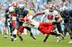 CHAPEL HILL, NC - OCTOBER 27: David Amerson #1 of the North Carolina State Wolfpack dives to bring down A.J.Blue #15 of the North Carolina Tar Heels during play at Kenan Stadium on October 27, 2012 in Chapel Hill, North Carolina. (Photo by Grant Halverson/Getty Images)