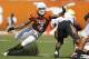 AUSTIN, TX - OCTOBER 15: Safety Kenny Vaccaro #4 of the Texas Longhorns attempts a first quarter tackle of running back Joseph Randall #1 of the Oklahoma State Cowboys on October 15, 2011 at Darrell K. Royal-Texas Memorial Stadium in Austin, Texas. Oklahoma State beat Texas 38-26. (Photo by Erich Schlegel/Getty Images)
