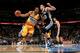DENVER, CO - DECEMBER 18: Andre Iguodala #9 of the Denver Nuggets drives with the ball against Manu Ginobili #20 of the San Antonio Spurs at the Pepsi Center on December 18, 2012 in Denver, Colorado. The Nuggets defeated the Spurs 112-106. NOTE TO USER: User expressly acknowledges and agrees that, by downloading and or using this photograph, User is consenting to the terms and conditions of the Getty Images License Agreement. (Photo by Doug Pensinger/Getty Images)