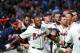 ATLANTA, GA - APRIL 6: Justin Upton #8 of the Atlanta Braves is congratulated by teammates after his ninth inning game-winning home run against the Chicago Cubs at Turner Field on April 6, 2013 in Atlanta, Georgia. (Photo by Scott Cunningham/Getty Images)