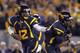 MORGANTOWN, WV - OCTOBER 20: Geno Smith #12 of the West Virginia Mountaineers hands the ball off against the Kansas State Wildcats during the game on October 20, 2012 at Mountaineer Field in Morgantown, West Virginia. (Photo by Justin K. Aller/Getty Images)