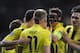 Centre of attention: Reus is congratulated after winning the penalty that gave Dortmund their fourth goal against Madrid