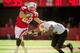 LINCOLN, NE - SEPTEMBER 22: Running back Rex Burkhead #22 of the Nebraska Cornhuskers stiff arms defensive back Cameron Gupton #28 of the Idaho State Bengals during their game at Memorial Stadium on September 22, 2012 in Lincoln, Nebraska. (Photo by Eric Francis/Getty Images)
