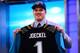 NEW YORK, NY - APRIL 25: Luke Joeckel of the Texas A&M Aggies holds up a jersey on stage after he was picked #2 overall by the Jacksonville Jaguars in the first round of the 2013 NFL Draft at Radio City Music Hall on April 25, 2013 in New York City. (Photo by Al Bello/Getty Images)