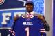 NEW YORK, NY - APRIL 25: E.J. Manuel of the Florida State Seminoles holds up a jersey on stage after he was picked #16 overall by the Buffalo Bills in the first round of the 2013 NFL Draft at Radio City Music Hall on April 25, 2013 in New York City. (Photo by Al Bello/Getty Images)