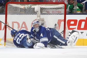 Mike Kostka takes a penalty while slamming into his own goaltender on the same play.