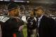 ORLANDO, FL - JANUARY 04: Former NFL player Chris Carter, R, and quarterback Russell Shepard #10 of the black team talk on the sideline as Carter's son Duron Carter #2 looks on during the All America Under Armour Football Game at Florida Citrus Bowl on January 4, 2009 in Orlando, Florida. (Photo by Doug Benc/Getty Images)