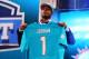 NEW YORK, NY - APRIL 25: Dion Jordan of the Oregon Ducks holds up a jersey on stage after he was picked #3 overall by the Miami Dolphins in the first round of the 2013 NFL Draft at Radio City Music Hall on April 25, 2013 in New York City. (Photo by Al Bello/Getty Images)