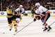 BOSTON, MA - APRIL 11: Mark Streit #2 of the New York Islanders is hit in the face with the stick of Tyler Seguin #19 of the Boston Bruins following a shot during the third period at the TD Garden on April 11, 2013 in Boston, Massachusetts. (Photo by Alex Trautwig/Getty Images)