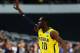 ARLINGTON, TX - MARCH 31: Tim Hardaway Jr. #10 of the Michigan Wolverines celebrates a three pointer in the first half against the Florida Gators during the South Regional Round Final of the 2013 NCAA Men's Basketball Tournament at Dallas Cowboys Stadium on March 31, 2013 in Arlington, Texas. (Photo by Tom Pennington/Getty Images)