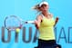 MADRID, SPAIN - MAY 05: Caroline Wozniacki of Denmark in action against Yaroslava Shvedova of Kazakhstan during day two of the Mutua Madrid Open tennis tournament at the Caja Magica on May 5, 2013 in Madrid, Spain. (Photo by Julian Finney/Getty Images)