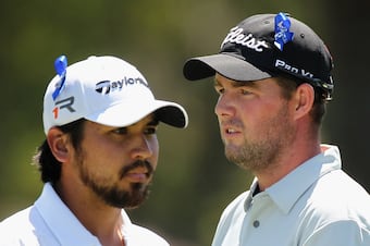 Marc Leishman (right) talks things over with fellow Aussie, Jason Day.
