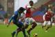 WIGAN, ENGLAND - DECEMBER 22: Jean Beausejour of Wigan Athletic brings down Theo Walcott of Arsenal to concede a penalty during the Barclays Premier League match between Wigan Athletic and Arsenal at the DW Stadium on December 22, 2012 in Wigan, England. (Photo by Clive Brunskill/Getty Images)