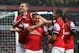LONDON, ENGLAND - MAY 14: Lukas Podolski (2nd left) of Arsenal celebrates with team mates after scoring during the Barclays Premier League match between Arsenal and Wigan Athletic at Emirates Stadium on May 14, 2013 in London, England. (Photo by Shaun Botterill/Getty Images)