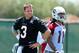 Carson Palmer (left) and Larry Fitzgerald work at OTAs.