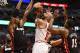 May 13, 2013; Chicago, IL, USA; Chicago Bulls power forward Carlos Boozer (5) shoots the ball against Miami Heat center Chris Bosh (1) and point guard Mario Chalmers (15) during the second half at the United Center. Miami defeats Chicago 88-65. Mandatory Credit: Mike DiNovo-USA TODAY Sports