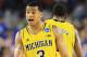 ARLINGTON, TX - MARCH 29: Trey Burke #3 of the Michigan Wolverines celebrates during overtime against the Kansas Jayhawks during the South Regional Semifinal round of the 2013 NCAA Men's Basketball Tournament at Dallas Cowboys Stadium on March 29, 2013 in Arlington, Texas. The Michigan Wolverines defeated the Kansas Jayhawks 87 to 85. (Photo by Ronald Martinez/Getty Images)