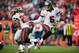 DENVER, CO - DECEMBER 2: Quarterback Josh Freeman #5 hands off to running back Doug Martin #22 of the Tampa Bay Buccaneers during a game against the Denver Broncos at Sports Authority Field Field at Mile High on December 2, 2012 in Denver, Colorado. (Photo by Dustin Bradford/Getty Images)