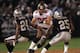 OAKLAND, CA - SEPTEMBER 26: Ken Dilger #85 of the Tampa Bay Buccaneers runs with the ball after a catch against Charles Woodson #24 and Denard Walker #25 of the Oakland Raiders on September 26, 2004 at Network Associates Coliseum in Oakland, California. The Raiders defeated the Buccaneers 30-20. (Photo by Stephen Dunn/Getty Images)
