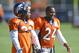 July 30, 2012; Englewood, CO, USA; Denver Broncos defensive back Tracy Porter (22) talks to Denver Broncos defensive back Champ Bailey (24) during training camp drills at the Broncos training facility. Mandatory Credit: Ron Chenoy-USA TODAY Sports