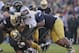 SOUTH BEND, IN - NOVEMBER 17: Deandre Martin #21 of the Wake Forest Demon Deacons is tackled by (L-R) Sheldon Day #91; Carlo Calabrese #44 and Louis Nix III #9 of the Notre Dame Fighting Irish at Notre Dame Stadium on November 17, 2012 in South Bend, Indiana. Notre Dame defeated Wake Forest 38-0. (Photo by Jonathan Daniel/Getty Images)