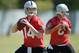 May 20, 2013; Alameda, CA, USA; Oakland Raiders quarterbacks Matt McGloin (14) and Tyler Wilson (8) throw a pass at organized team activities at the Raiders practice facility. Mandatory Credit: Kirby Lee-USA TODAY Sports