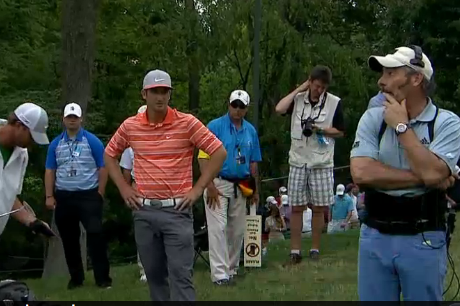 Feherty looks on.
