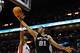 MIAMI, FL - JANUARY 17: Tim Duncan #21 of the San Antonio Spurs drives to the basket during a game against Chris Bosh #1 of the Miami Heat at American Airlines Arena on January 17, 2012 in Miami, Florida. NOTE TO USER: User expressly acknowledges and agrees that, by downloading and/or using this Photograph, User is consenting to the terms and conditions of the Getty Images License Agreement. (Photo by Mike Ehrmann/Getty Images)
