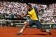 PARIS, FRANCE - JUNE 04: Jo-Wilfried Tsonga of France plays a backhand in his Men's Singles quarter final match against Roger Federer of Switzerland during day ten of the French Open at Roland Garros on June 4, 2013 in Paris, France. (Photo by Matthew Stockman/Getty Images)