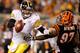 CINCINNATI - NOVEMBER 08: Quarterback Ben Roethlisberger #7 of the Pittsburgh Steelers breaks free from Geno Atkins #97 of the Cincinnati Bengals at Paul Brown Stadium on November 8, 2010 in Cincinnati, Ohio. The Steelers defeated the Bengals 27-21. (Photo by Matthew Stockman/Getty Images)