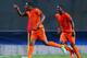 PETAH TIQWA, ISRAEL - JUNE 06: Leroy Fer (L) of Netherlands celebrates his team's third goal with team mate Ola John during the UEFA European Under 21 Championship match between Netherlands and Germany at Ha Moshava Stadium on June 6, 2013 in Petah Tiqwa, Israel. (Photo by Alex Grimm/Getty Images)