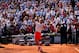 PARIS, FRANCE - JUNE 07: Rafael Nadal of Spain throws his sweat band into the crowd as he celebrates match point in the men's singles semi-final match against Novak Djokovic of Serbia on day thirteen of the French Open at Roland Garros on June 7, 2013 in Paris, France. (Photo by Clive Brunskill/Getty Images)
