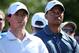 ABU DHABI, UNITED ARAB EMIRATES - JANUARY 18: and Tiger Woods of the USA (R) and Rory McIlroy of Northern Ireland (L) look on during the second round of The Abu Dhabi HSBC Golf Championship at Abu Dhabi Golf Club on January 18, 2013 in Abu Dhabi, United Arab Emirates. (Photo by Andrew Redington/Getty Images)