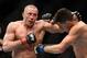 Mar 16, 2013; Montreal, Quebec, CAN; Georges St.Pierre (red) and Nick Diaz (blue) exchange blows during their Welterweight title bout at UFC 158 at the Bell Centre. Mandatory Credit: Eric Bolte-USA TODAY Sports