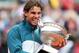 PARIS, FRANCE - JUNE 09: Rafael Nadal of Spain bites the Coupe des Mousquetaires trophy as he celebrates victory in the men's singles final against David Ferrer of Spain during day fifteen of the French Open at Roland Garros on June 9, 2013 in Paris, France. (Photo by Matthew Stockman/Getty Images)