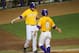 Jun 2, 2013; Baton Rouge, LA, USA; LSU Tigers infielder Mason Katz (8) is congratulated by Alex Edward (13) after scoring a run on a walk in the fifth inning against the Louisiana-Lafayette Ragin Cajuns during the Baton Rouge regional of the 2013 NCAA baseball tournament at Alex Box Stadium. Mandatory Credit: Crystal LoGiudice-USA TODAY Sports