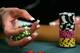 LAS VEGAS - JULY 30: Poker player Liz Lieu plays with her chips as she competes on the third day of the first round of the World Series of Poker no-limit Texas Hold 'em main event at the Rio Hotel & Casino July 30, 2006 in Las Vegas, Nevada. More than 8,600 players have registered to play in the main event. The final nine players will compete for the top prize of more than USD 11.7 million on the final table which begins August 10. (Photo by Ethan Miller/Getty Images)