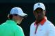 ARDMORE, PA - JUNE 12: Tiger Woods (R) of the United States and Rory McIlroy (L) of Northern Ireland walk across a green during a practice round prior to the start of the 113th U.S. Open at Merion Golf Club on June 12, 2013 in Ardmore, Pennsylvania. (Photo by Andrew Redington/Getty Images)