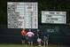 Jun 13, 2013; Ardmore, PA, USA; Spectators look over a leaderboard on the 12th hole as a weather warning sign is displayed during the first round of the 113th U.S. Open golf tournament at Merion Golf Club. Mandatory Credit: JD Mercer-USA TODAY Sports