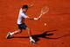 PARIS, FRANCE - JUNE 04: Roger Federer of Switzerland plays a backhand in his Men's Singles quarter final match against Jo-Wilfried Tsonga of France during day ten of the French Open at Roland Garros on June 4, 2013 in Paris, France. (Photo by Clive Brunskill/Getty Images)