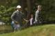 Jun 14, 2013; Ardmore, PA, USA; Tiger Woods (left) and Rory McIlroy (right) smile while walking to the 15th green during the second round of the 113th U.S. Open golf tournament at Merion Golf Club.. Mandatory Credit: Michael Madrid-USA TODAY