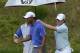 Jun 13, 2013; Ardmore, PA, USA; Tiger Woods (front) shakes hands with caddie J.P. Fitzgerald (back, left) as Rory McIlroy (right) approaches during the first round of the 113th U.S. Open golf tournament at Merion Golf Club. Mandatory Credit: Eileen Blass-USA TODAY
