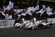 LE MANS, FRANCE - JUNE 17: The first placed Audi Sport Team Joest R18 E-Tron Quattro of Andre Lotterer, Marcel Fassler and Benoit Treluyer (R) and the second placed The Audi Sport R18 E-Tron Quattro of Allan McNish, Tom Kristensen and Dindo Capello (L) drive past their team mates at the end of the Le Mans 24 Hour race at the Circuit de la Sarthe on June 16, 2012 in Le Mans, France. (Photo by Ker Robertson/Getty Images)
