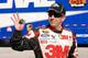 Greg Biffle waves to fans as he walks through the Daytona International Speedway garage. Credit: Dwight Drum