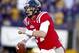 November 17, 2012; Baton Rouge, LA, USA; Ole Miss Rebels quarterback Bo Wallace (14) scrambles against the LSU Tigers during the first half of a game at Tiger Stadium. Mandatory Credit: Derick E. Hingle-USA TODAY Sports