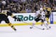 Jun 17, 2013; Boston, MA, USA; Chicago Blackhawks right wing Patrick Kane (88) skates with the puck between Boston Bruins defenseman Zdeno Chara (33) and left wing Brad Marchand (63) during the second period in game three of the 2013 Stanley Cup Final at TD Garden. Mandatory Credit: Greg M. Cooper-USA TODAY Sports