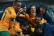 SYDNEY, AUSTRALIA - JUNE 18: Matt McKay of the Socceroos (C) and team mates celebrate after Josh Kennedy scored a goal during the FIFA 2014 World Cup Asian Qualifier match between the Australian Socceroos and Iraq at ANZ Stadium on June 18, 2013 in Sydney, Australia. (Photo by Cameron Spencer/Getty Images)